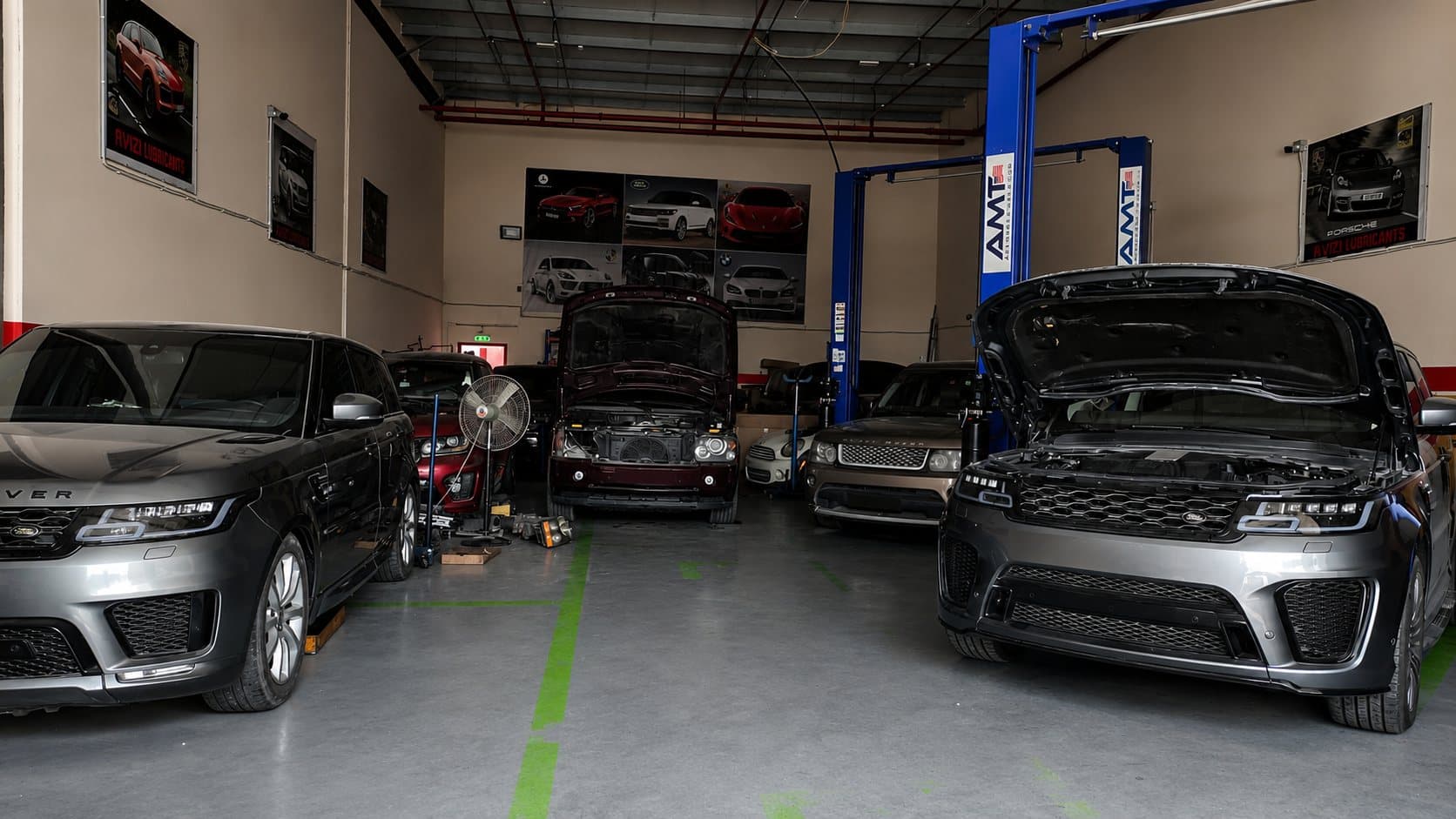 Range Rover and Land Rover vehicles on the ramps inside the GAS AUTO workshop in Sharjah