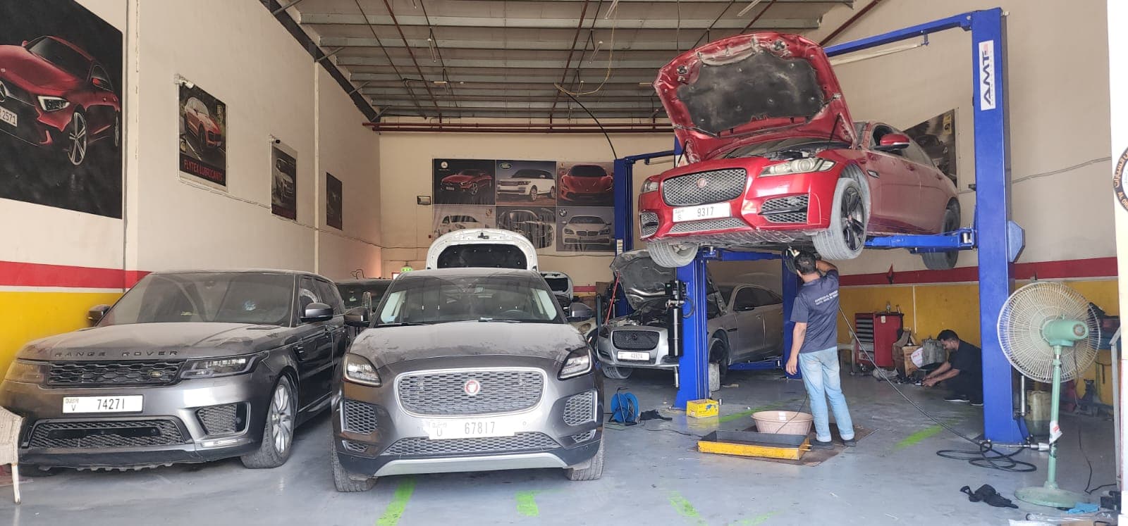 Inside the GAS AUTO workshop, with vehicles raised on two-post lifts across several bays